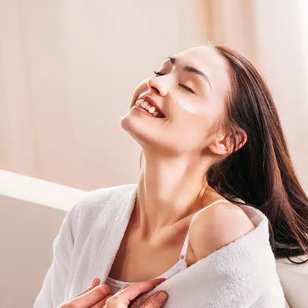 young smiling woman in white bathrobe relaxing on ZUKZZS8