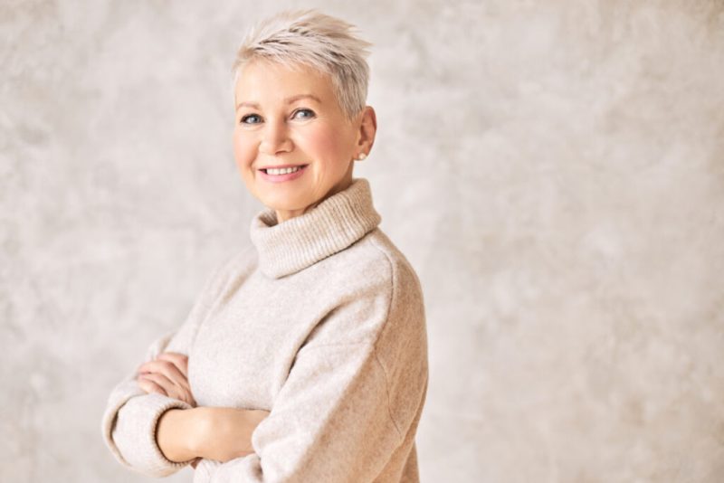 beautiful happy retired woman wearing cozy sweater short hairdo