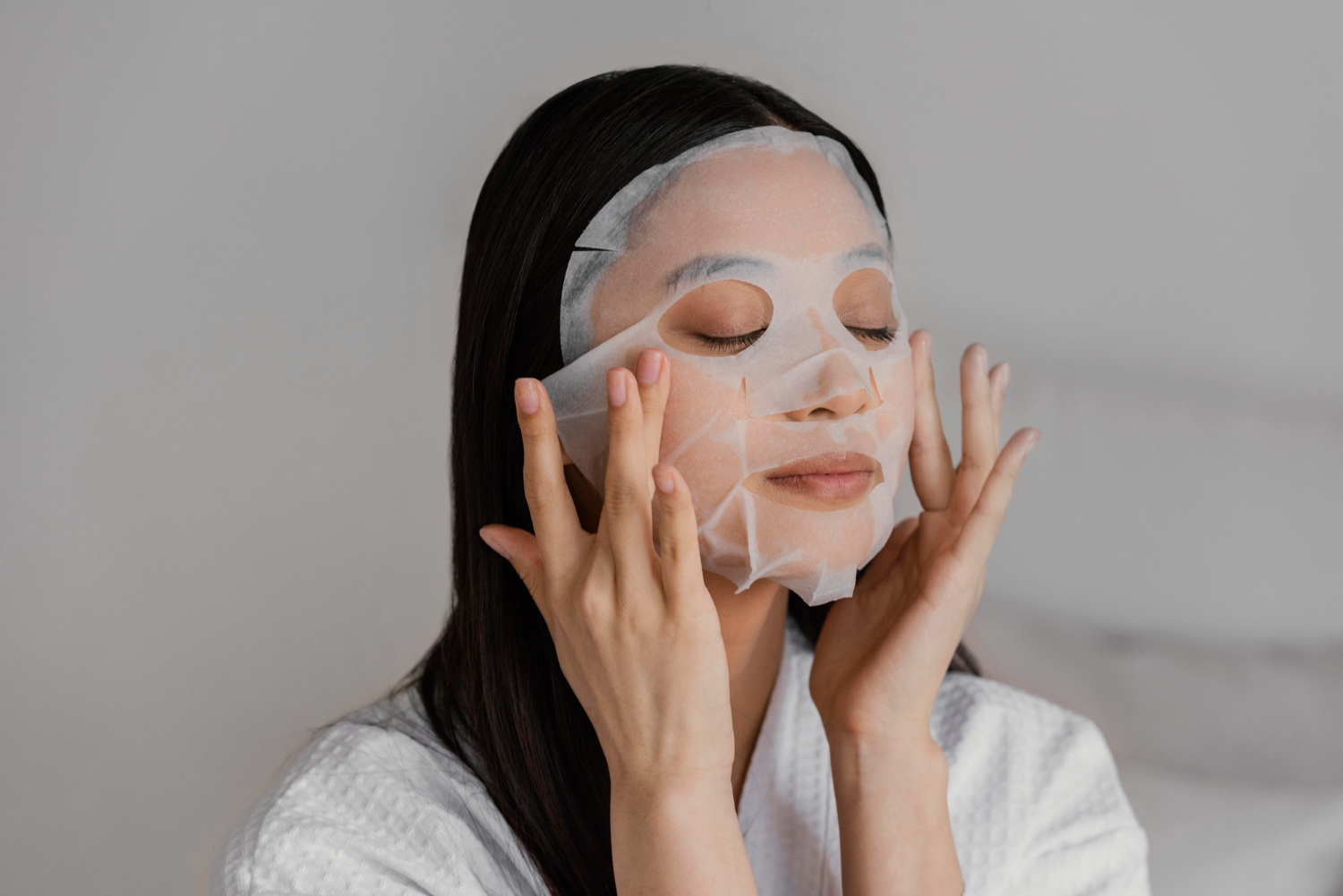 asian woman using sheet mask