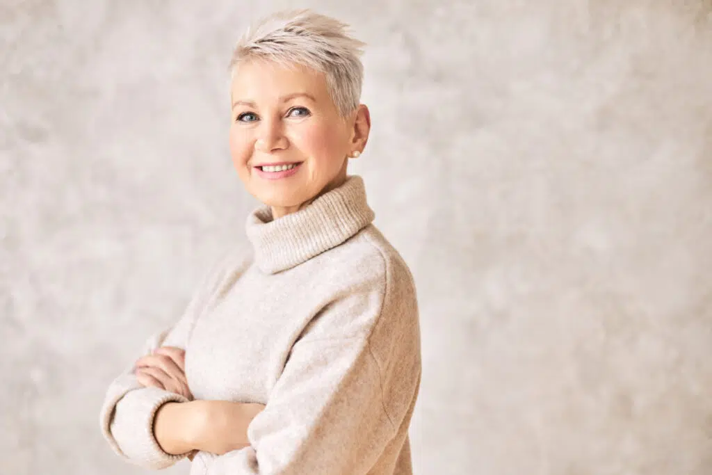 beautiful happy retired woman wearing cozy sweater short hairdo