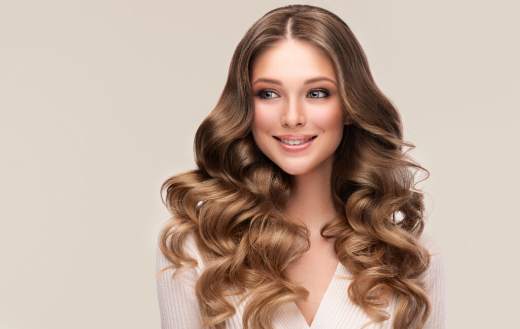 portrait deep blonde haired woman with elegant wavy long hairstyle wearing exquisite makeup