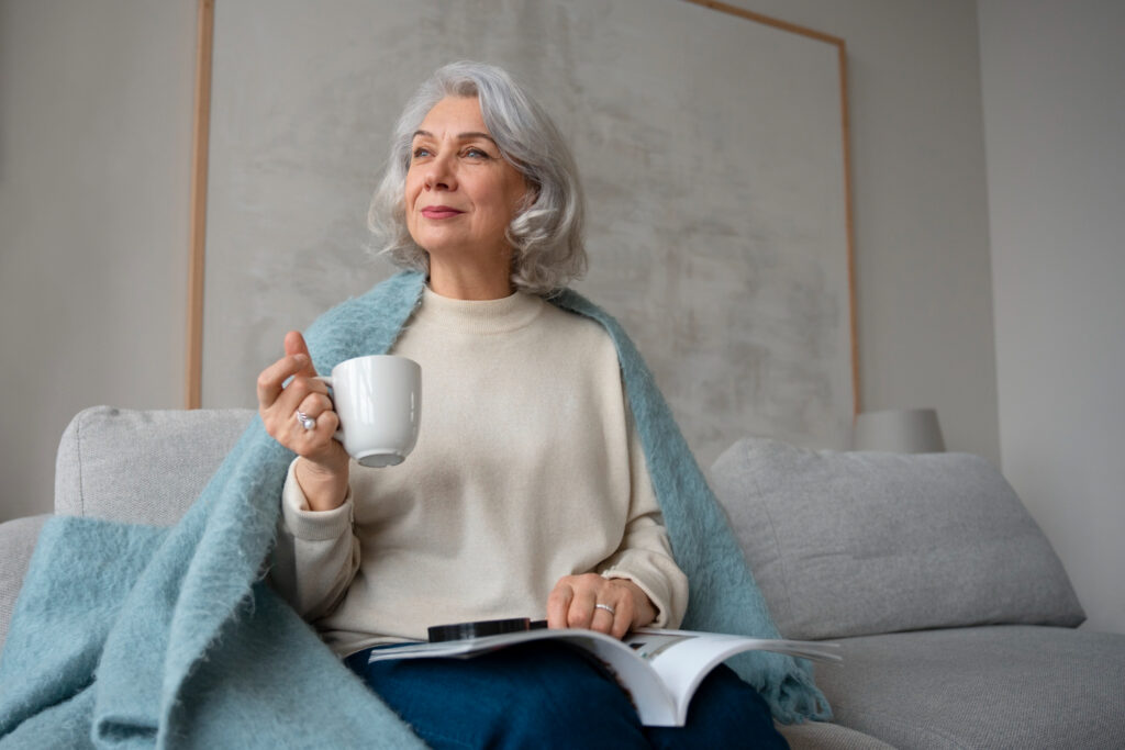 elderly woman reading while using magnifying glass