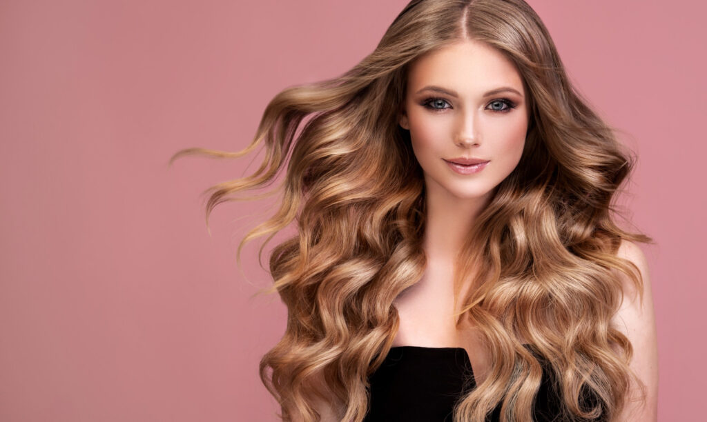 woman with perfect dense curls long lush deep blonde hair flying hair hairdressing art makeup